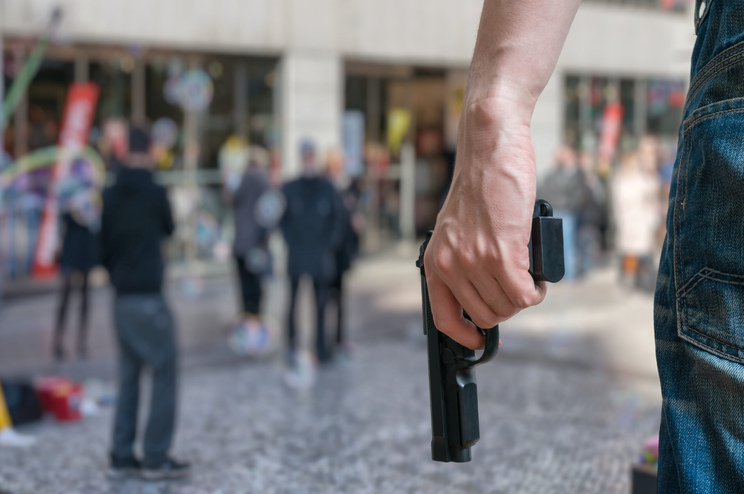 Man holding hand gun in public