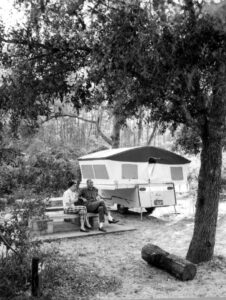 Campers set up at a tent site in a national forest, the kind of low-frills camping trip the 'tf not' trend mocks in favor of glamping