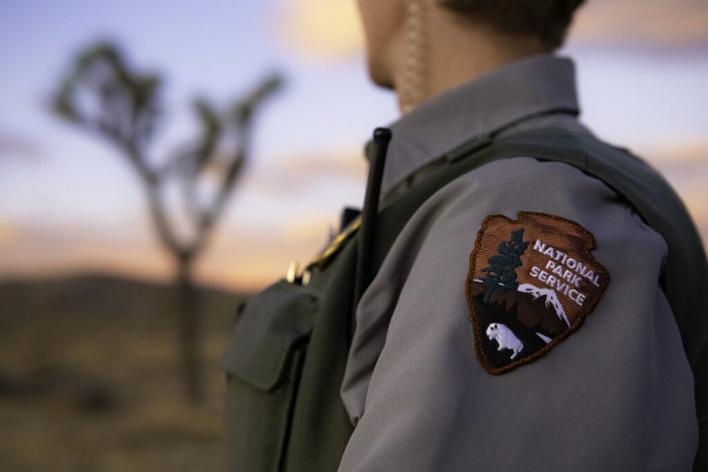 A National Park Service ranger; the agency has lost nearly a quarter of its permanent workforce since January 2025, and morale has fallen to a historic low