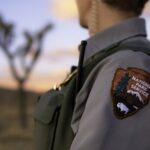 A National Park Service ranger; the agency has lost nearly a quarter of its permanent workforce since January 2025, and morale has fallen to a historic low