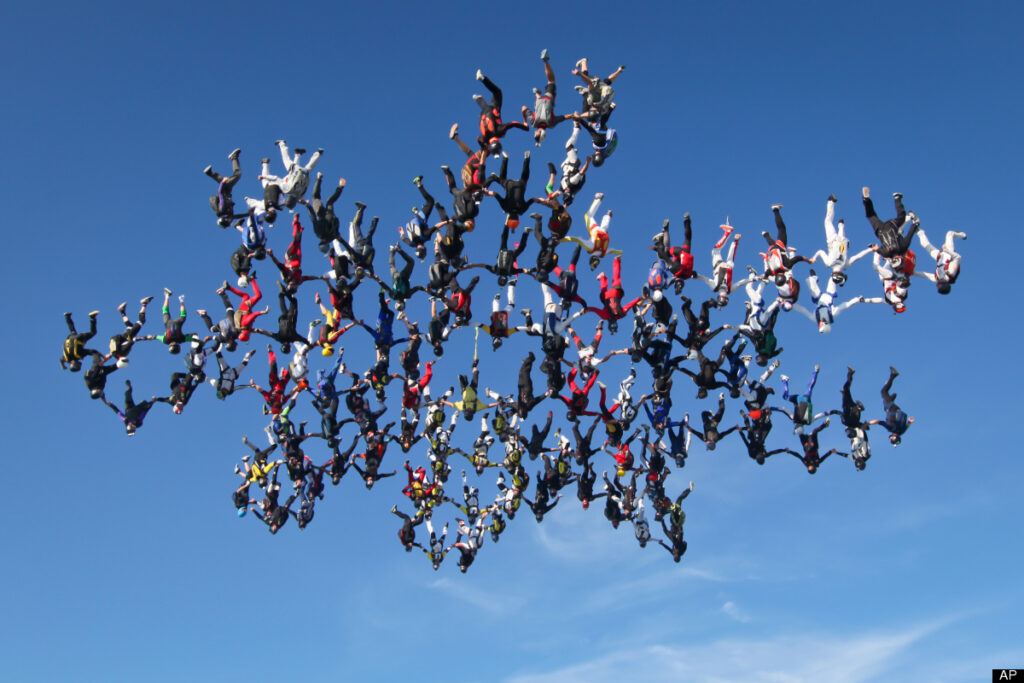 65 Skydivers Set Guinness World Record Jumping With National Flags Over Libya