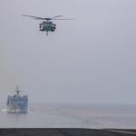 A US Navy carrier strike group transits the Strait of Hormuz, where US forces struck Iranian rocket launchers on Larak Island before Iran retaliated against American bases in Jordan