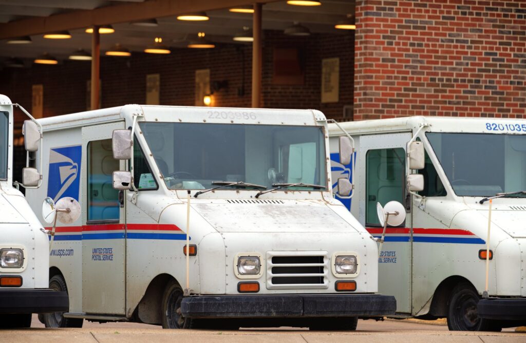 USPS mail carrier trucks; a federal judge canceled her own nationwide order blocking postal work on Trump's mail-in voting directive