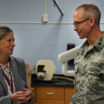 Amy Acton speaking with a National Guard dentist at a community health event