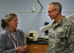 Amy Acton speaking with a National Guard dentist at a community health event