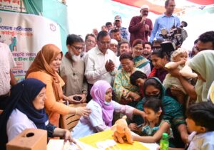 A health worker administers a measles-rubella vaccine to a child during a vaccination campaign in Dhaka, Bangladesh